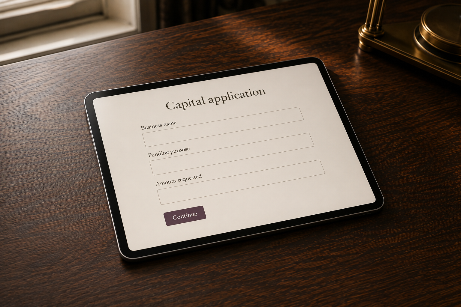 A tablet displaying an illustrative capital application on a walnut desk